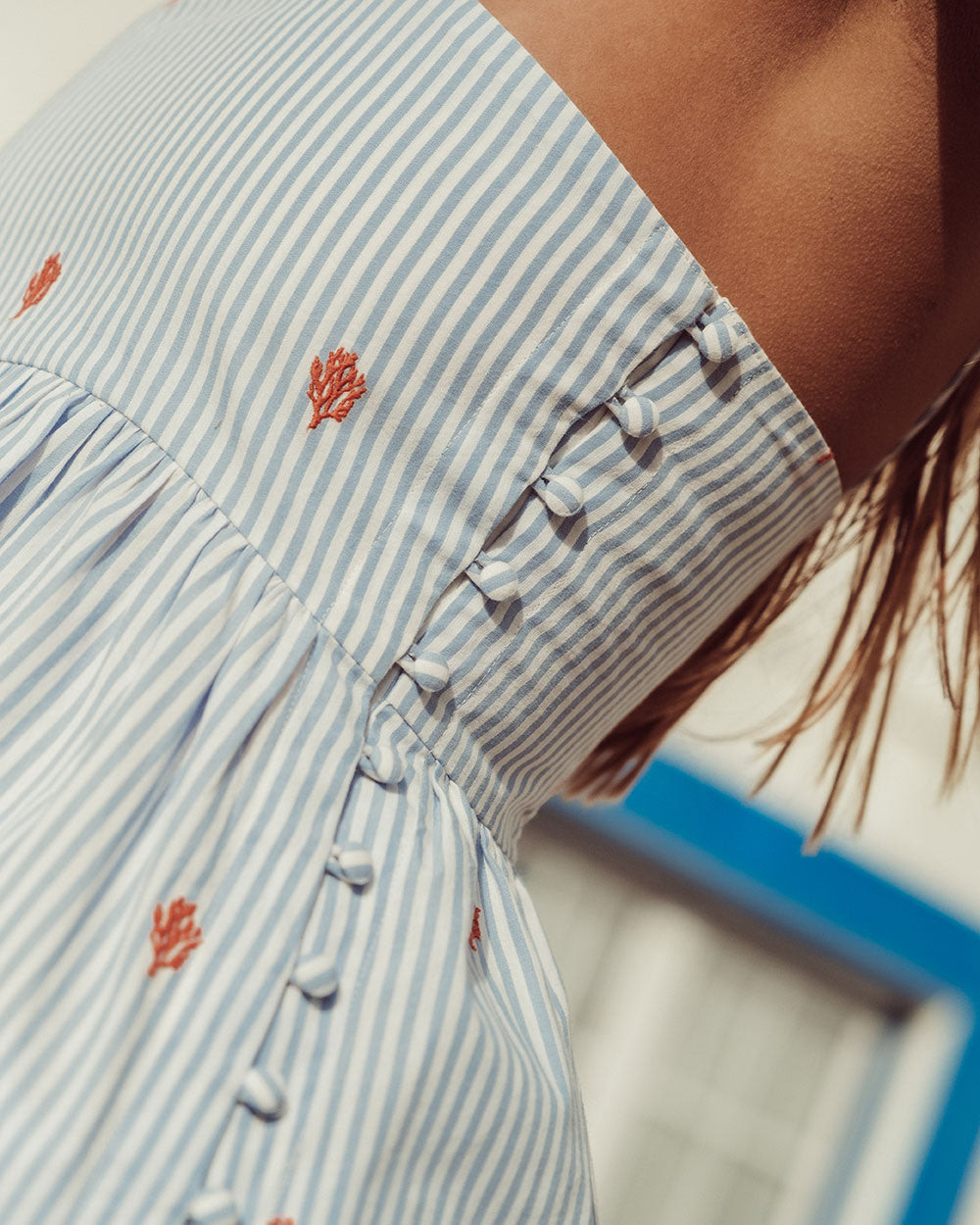 Top Ursa 100% algodón azul con líneas blancas, amarras en hombros y detalles bordados, top artesanal sostenible Chile.