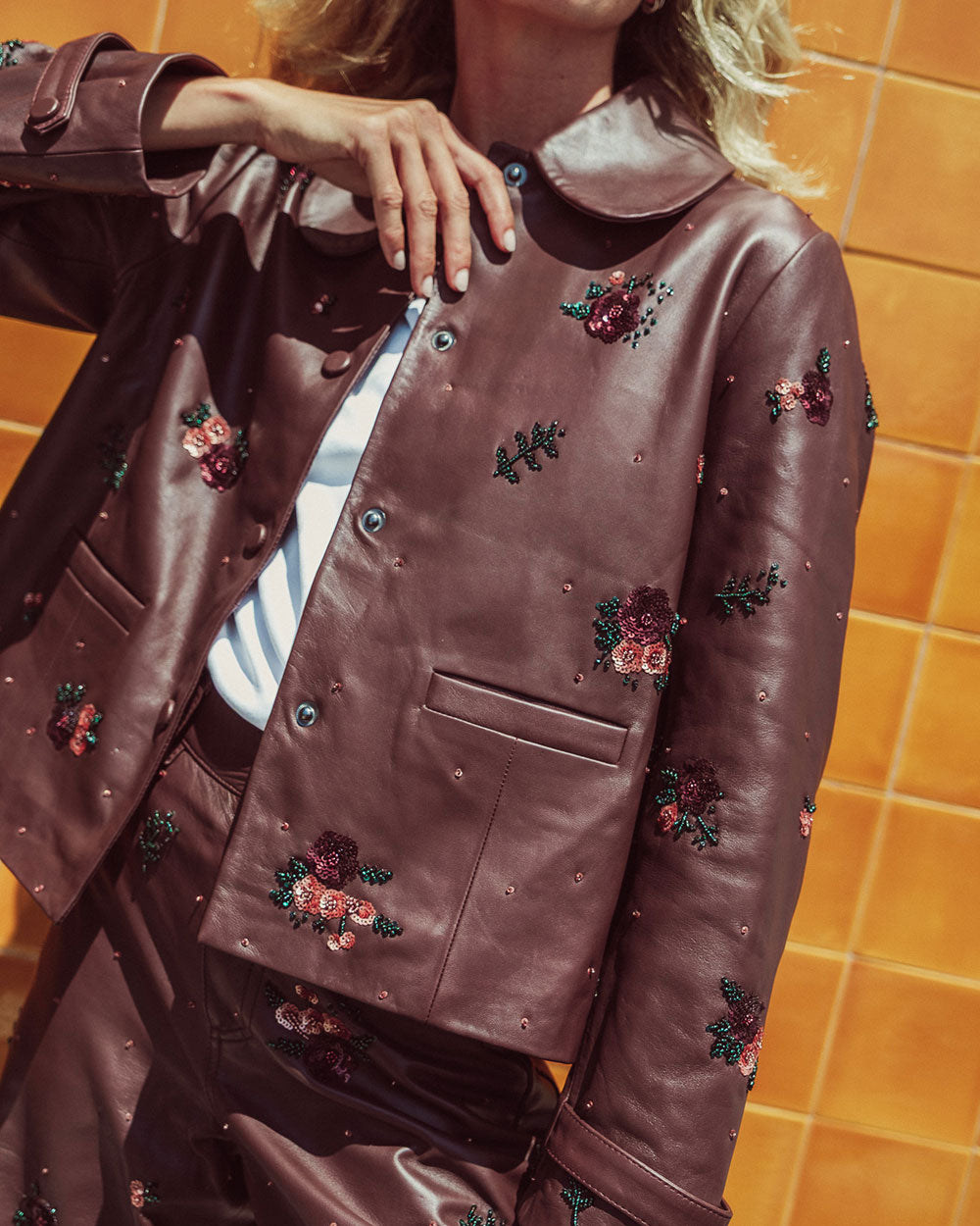 Chaqueta de cuero natural burdeo para mujer de corte recto con cuello redondo y bordados florales hechos a mano de la colección Her Story moda sostenible urco.