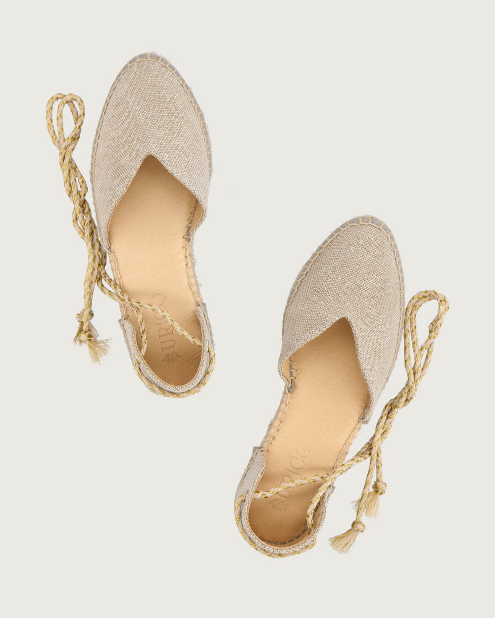 Alpargata Santorini de lona beige con brillos y cordones trenzados dorados, calzado atemporal hecho a mano en España.